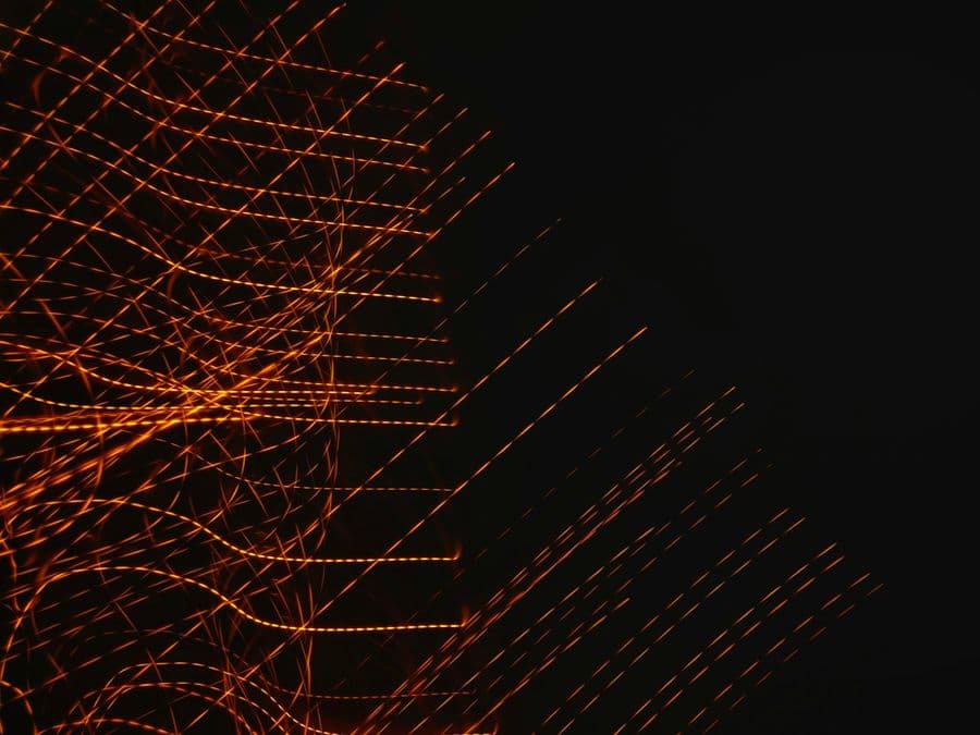 Lattice of orange light trails on black